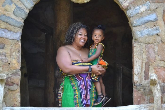 Picture of Shauna, a Black woman holding a child