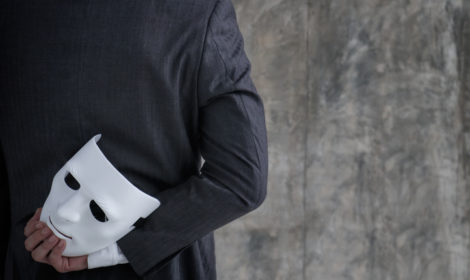 Man holding white mask in his hand