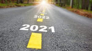 New year journey 2021 to 2024 on asphalt road surface with marking lines and sunlight
