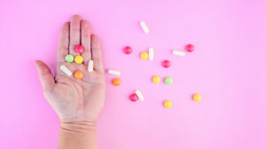 Woman hand and colorful pills